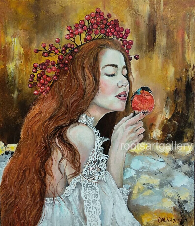 Red-haired girl with bullfinch bird